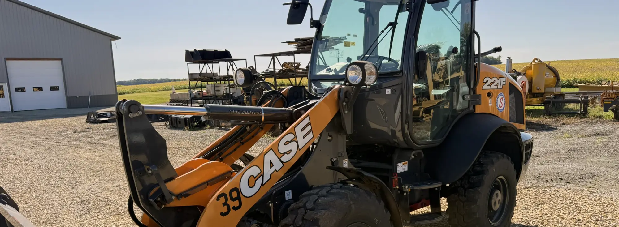 CASE 22F front loader in farmyard